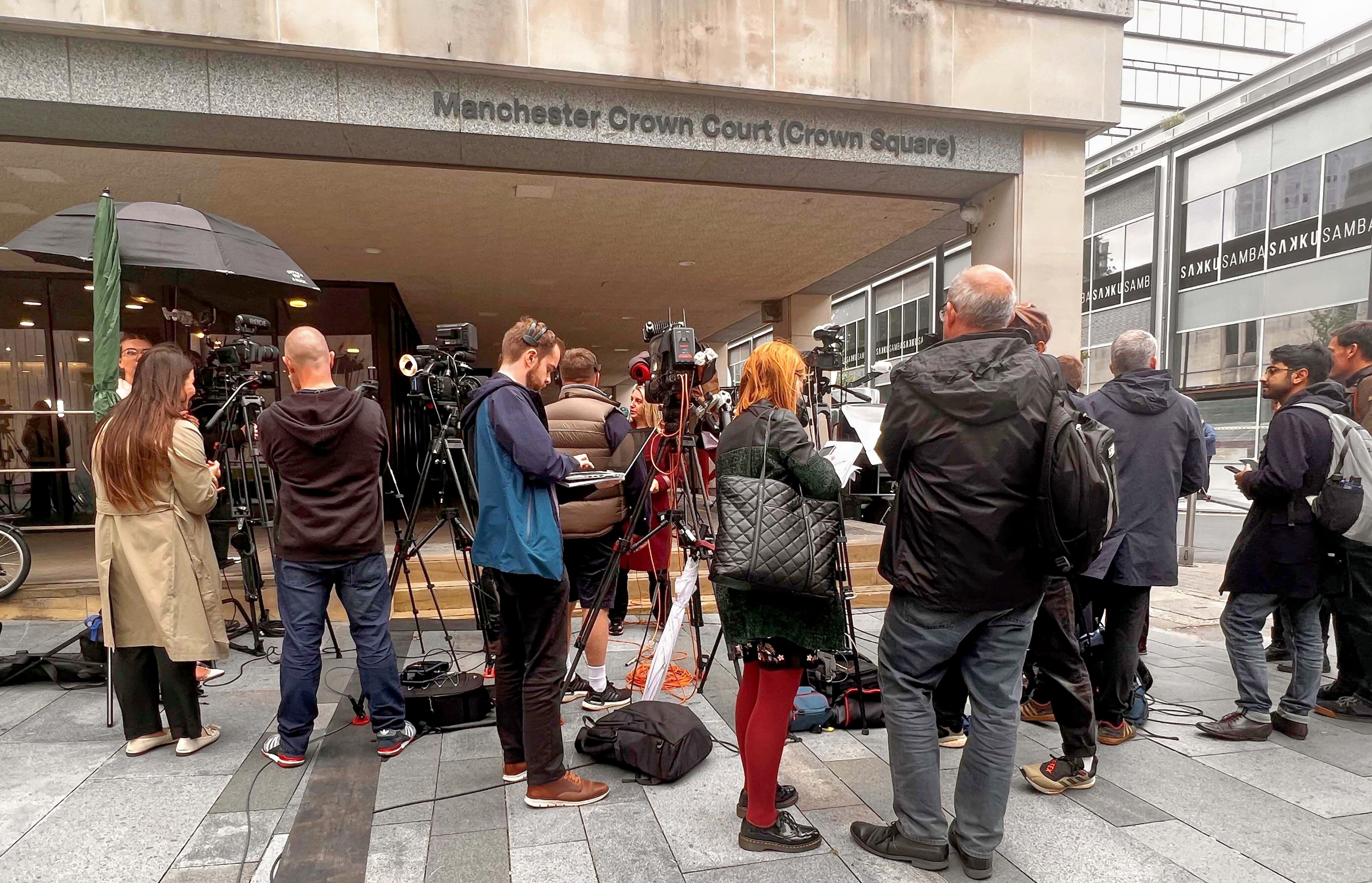 Journalists wait outside court