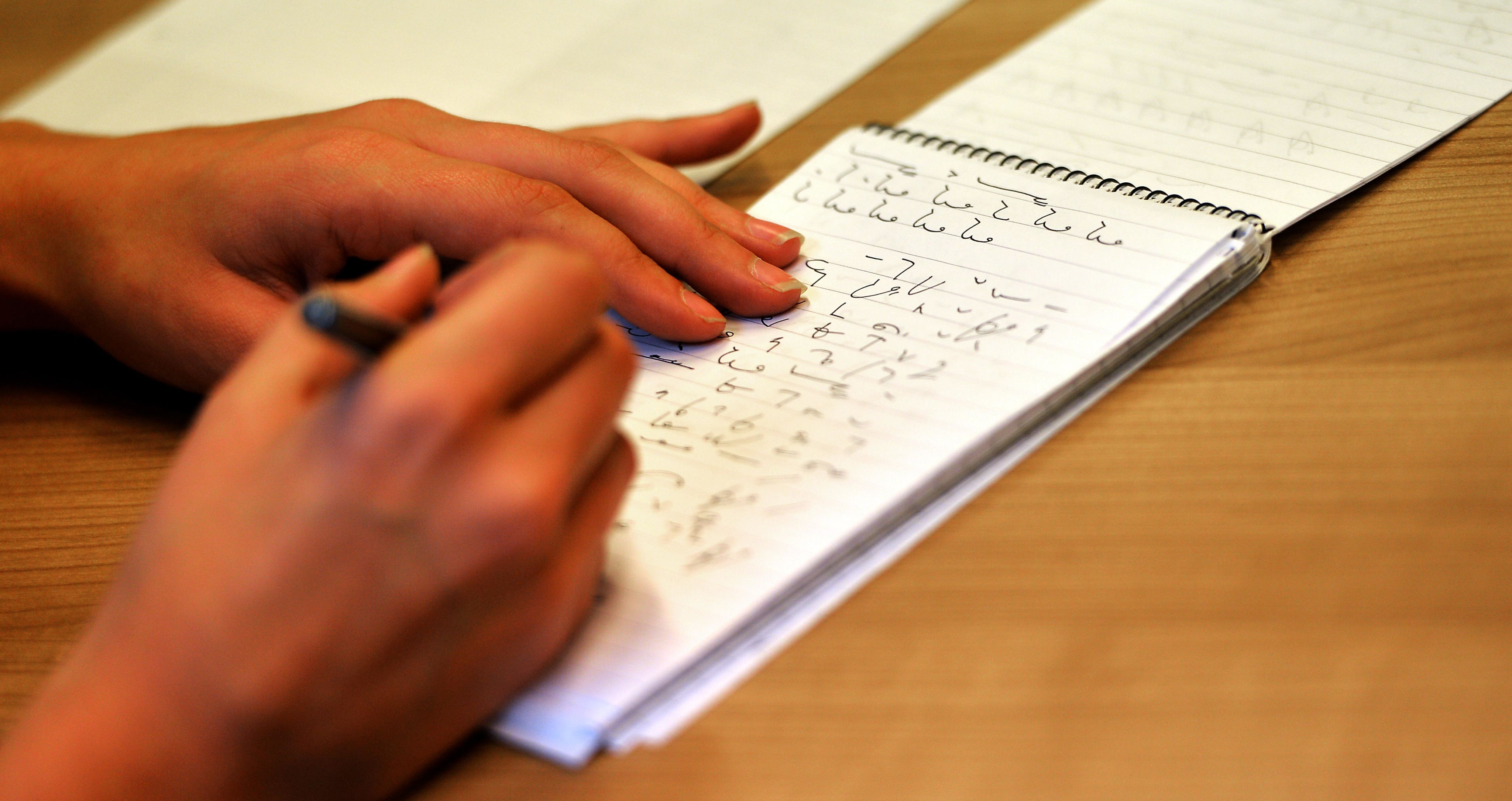 A reporter writing shorthand