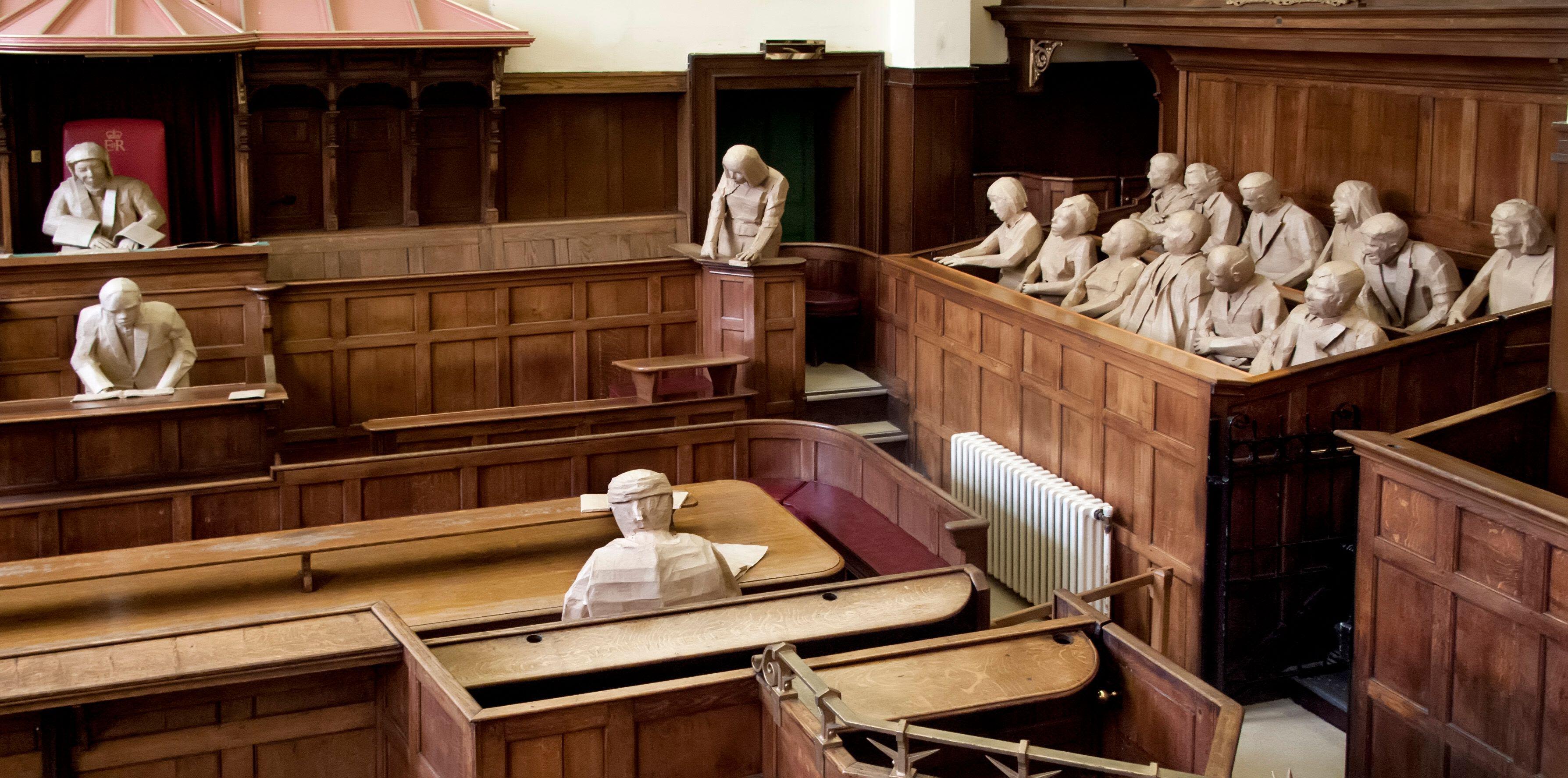 A courtroom showing fake figures in paper
